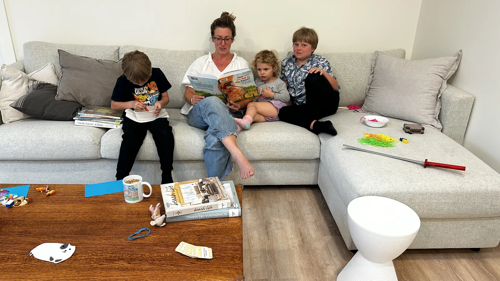 Caitlin and the kids on the couch after pickup, reading and drawing.